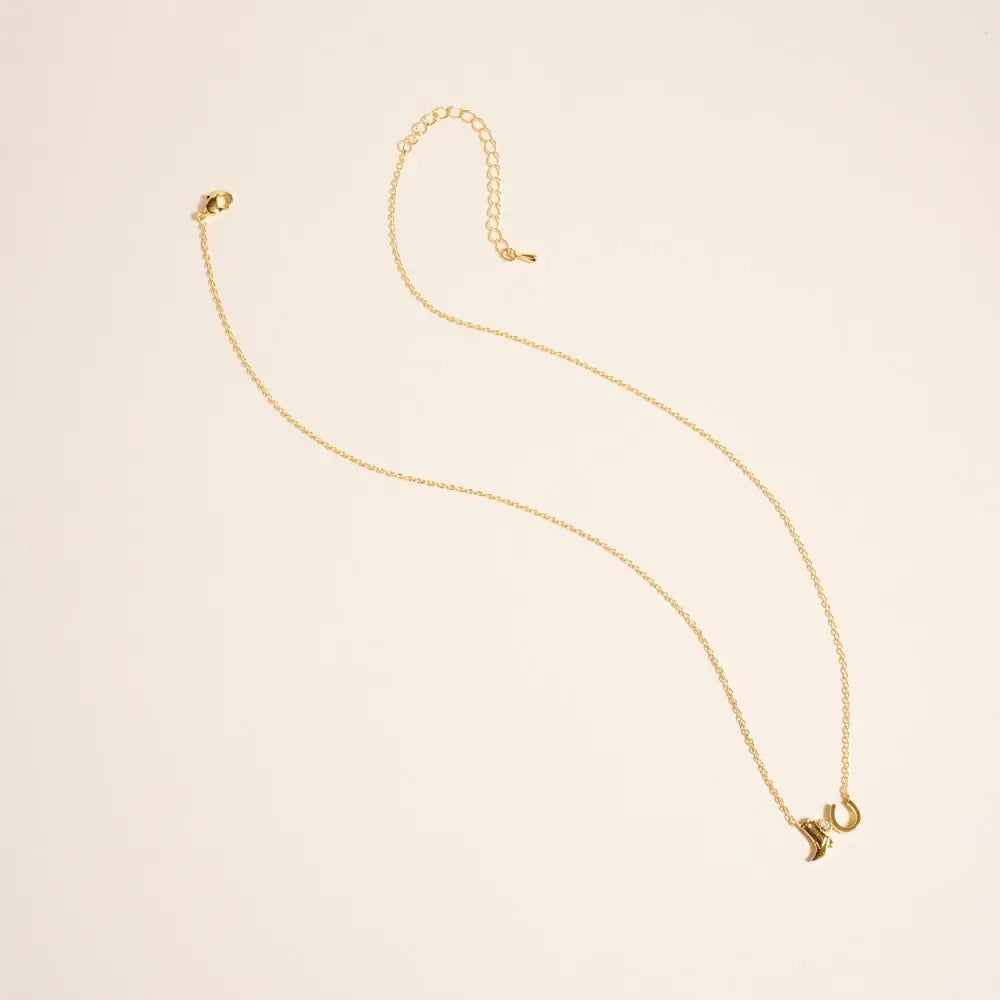 Gold necklace on a beige background