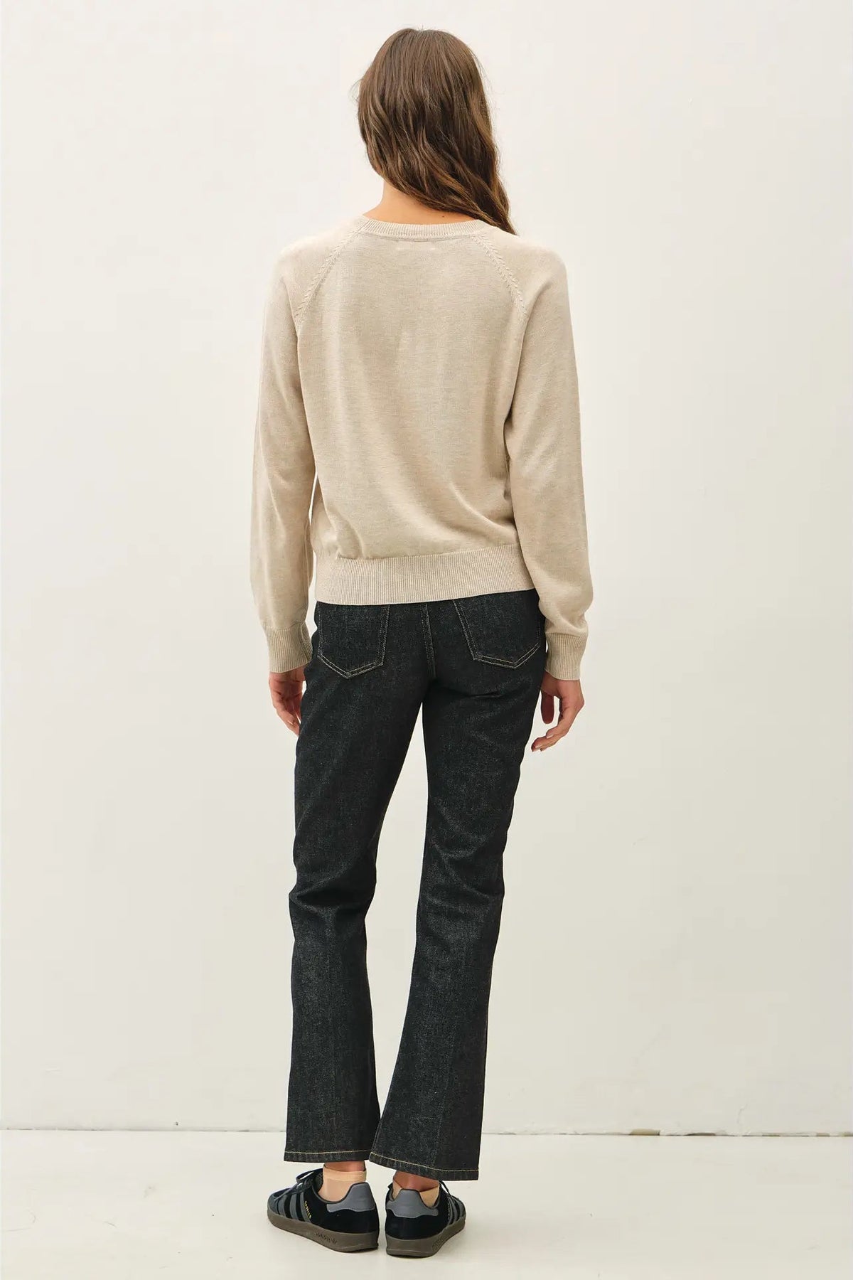 back view of woman in sweater and jeans