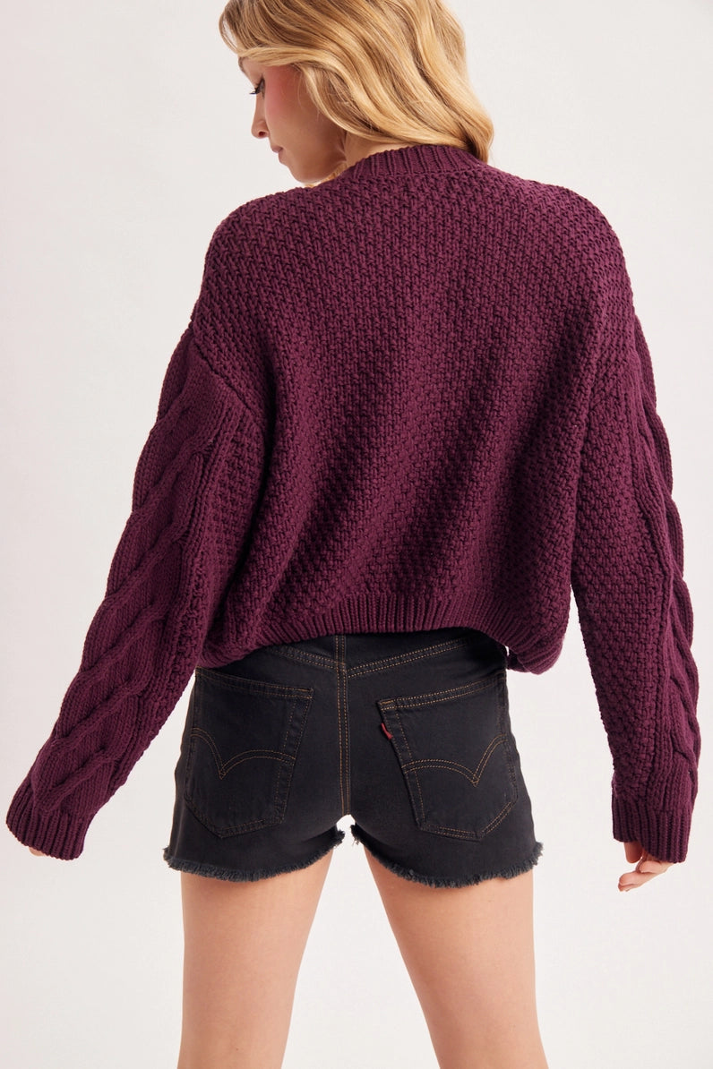 back view of person wearing cardigan and shorts