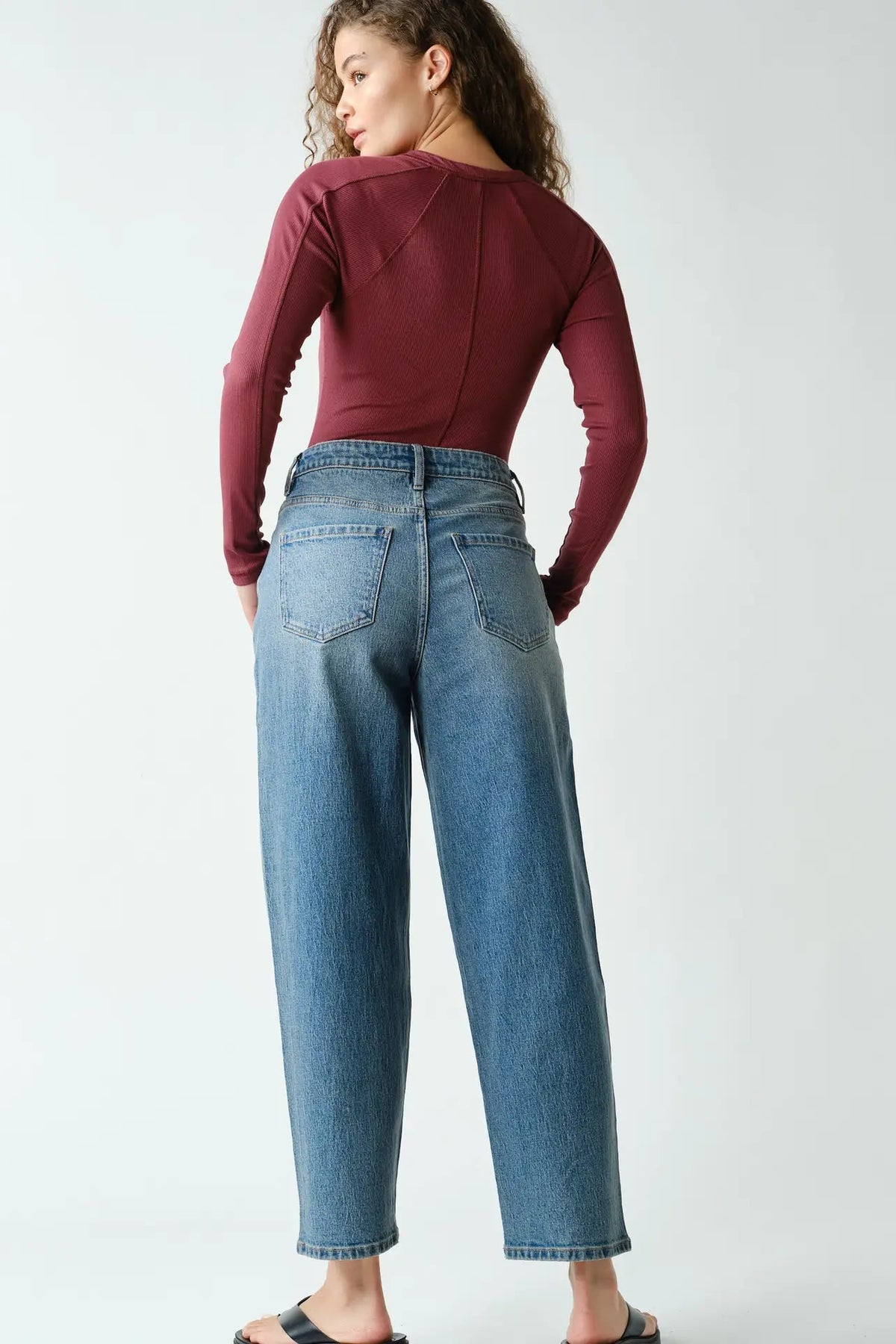 woman in henley long sleeve top and jeans