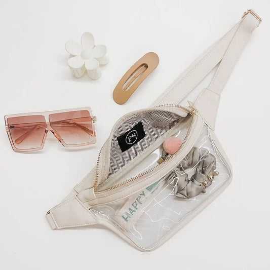 Beige waist bag with sunglasses, hair accessories, and a phone on a white background