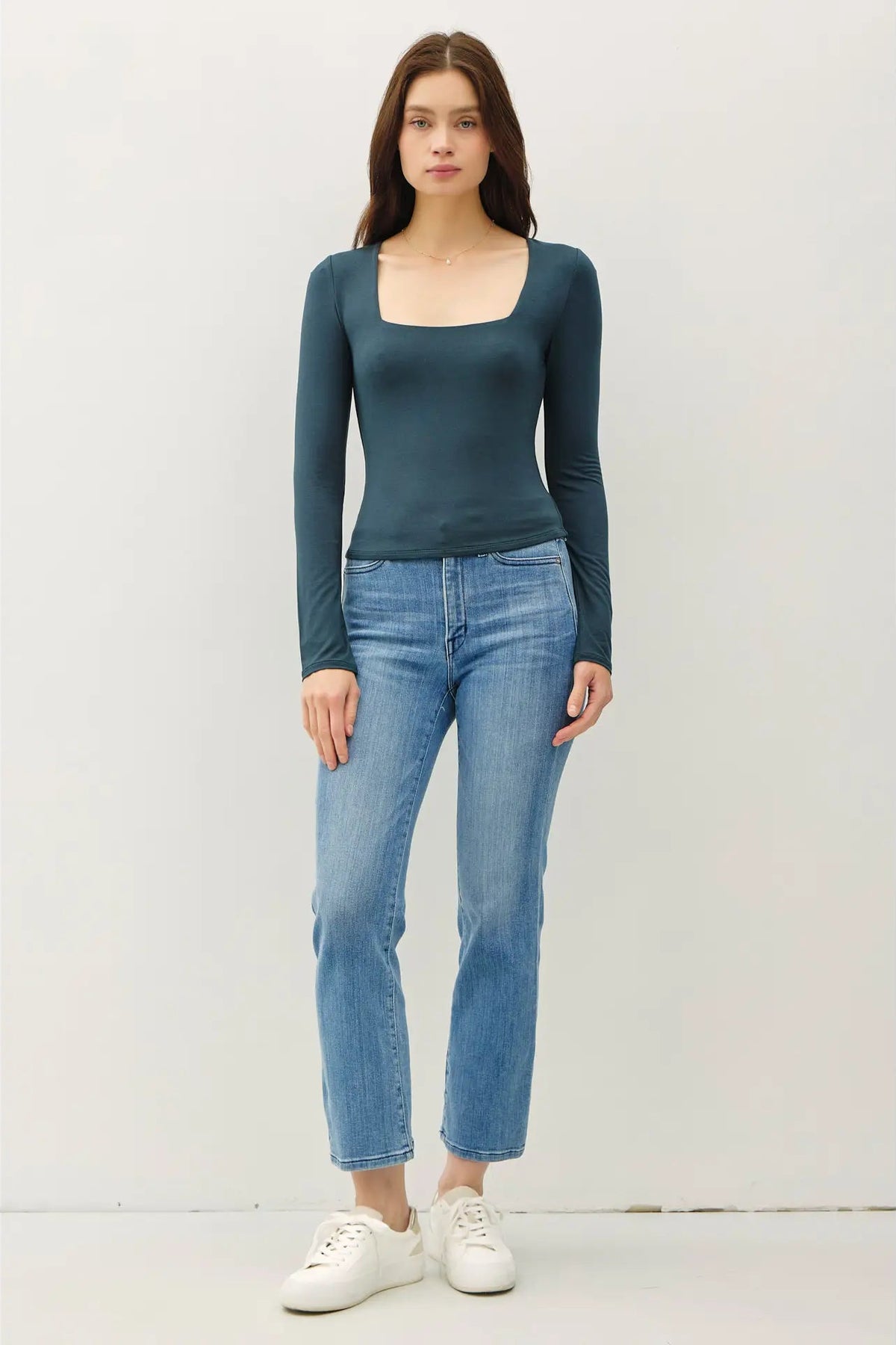 woman wearing square neck long sleeve top with jeans