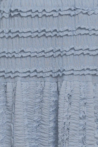 Close-up of a textured blue fabric with ruffled layers