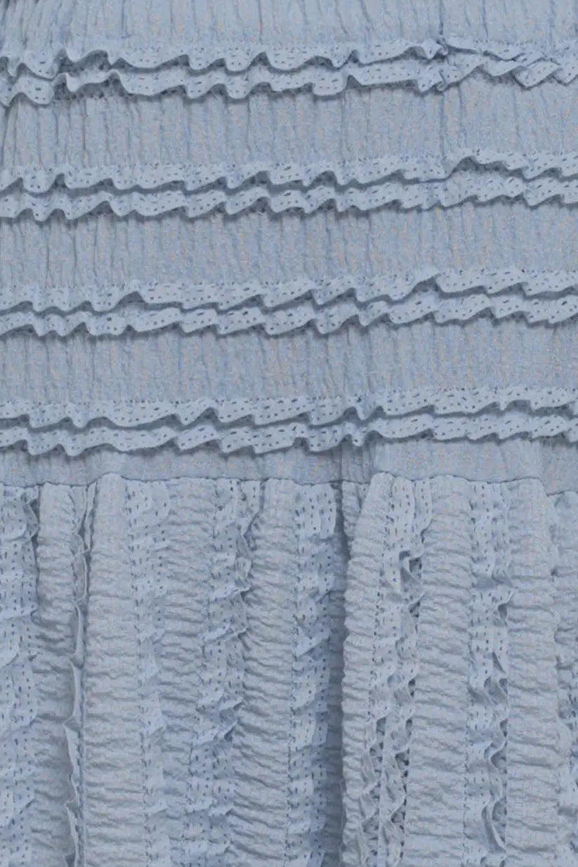 Close-up of a textured blue fabric with ruffled layers