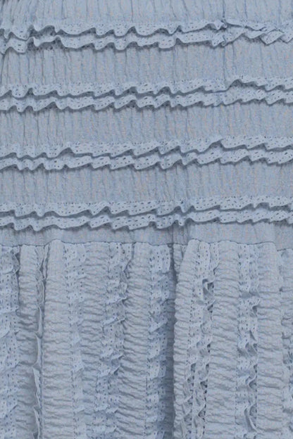 Close-up of a textured blue fabric with ruffled layers