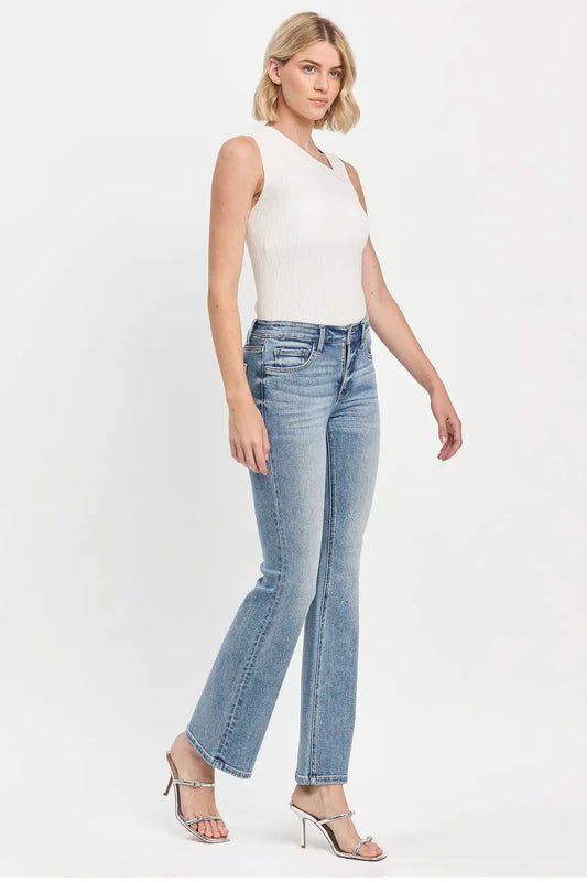 woman in white tank and light wash jeans