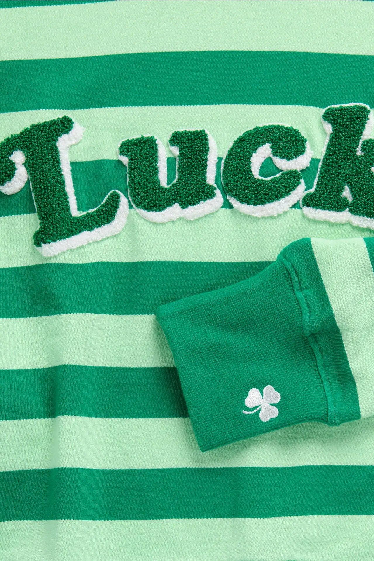 Green and white striped shirt with 'Luck' text and green socks on a matching background