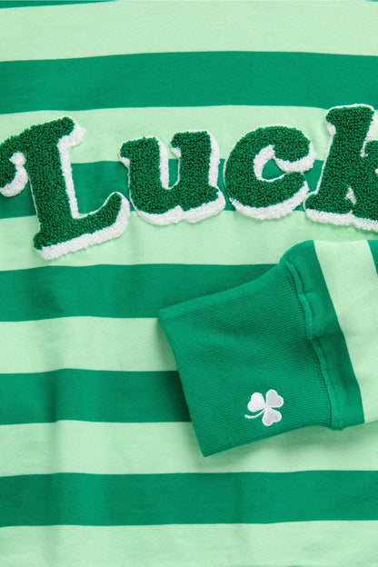 Green and white striped shirt with 'Luck' text and green socks on a matching background