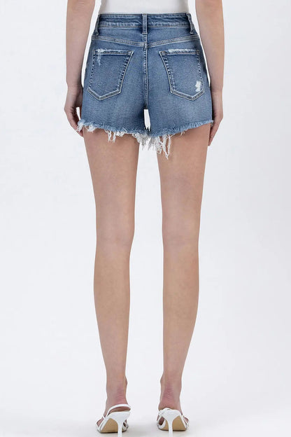 Person wearing denim shorts on a white background