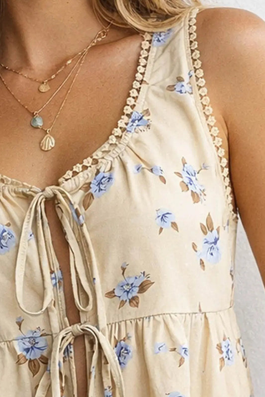 Beige floral dress with blue flowers and thin straps on a white background