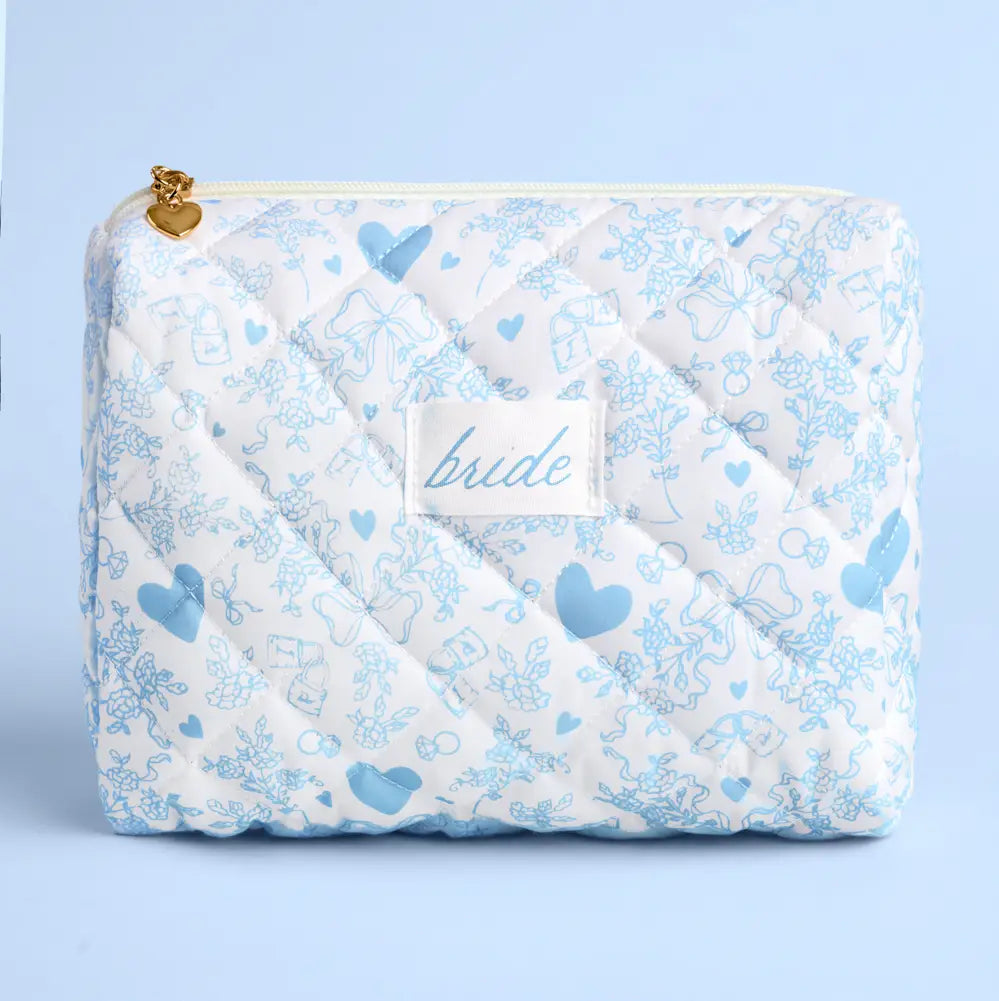 Quilted bag with blue heart and bow pattern and 'bride' label on a light blue background