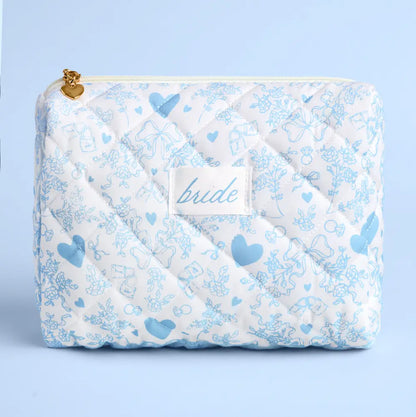 Quilted bag with blue heart and bow pattern and 'bride' label on a light blue background