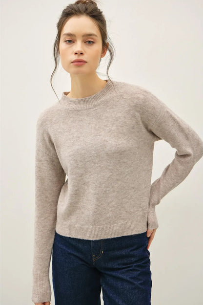 woman in gray sweater and jeans