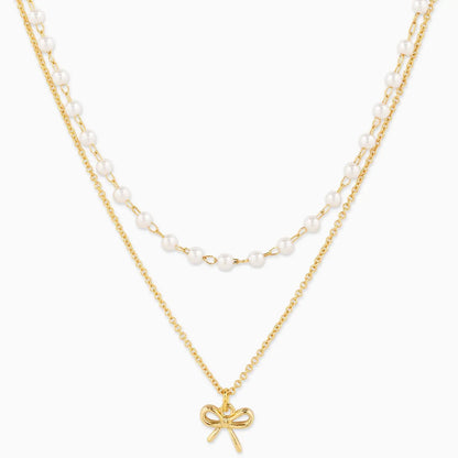 Double Layered Pearl Chain and Bow Pendant Necklace on white background