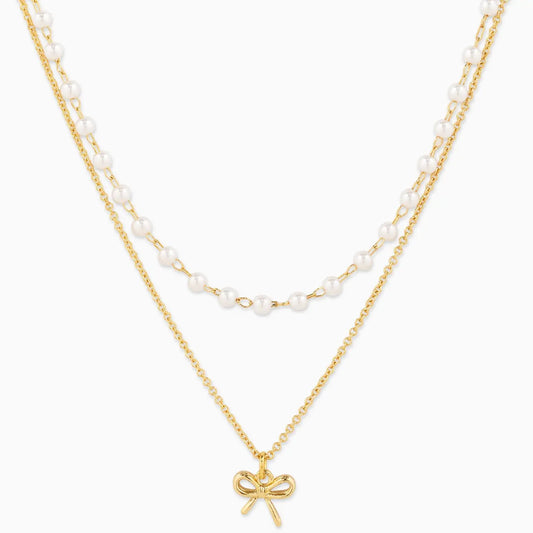 Double Layered Pearl Chain and Bow Pendant Necklace on white background