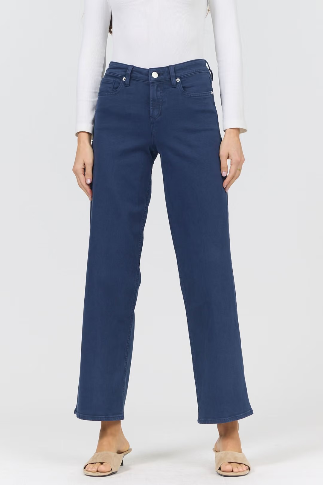 Person wearing blue jeans on a white background