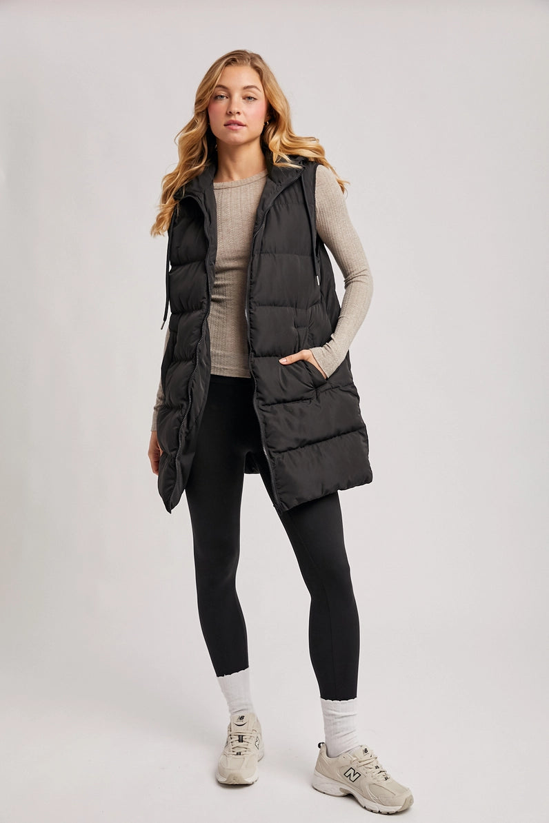 woman in puffer vest and leggings