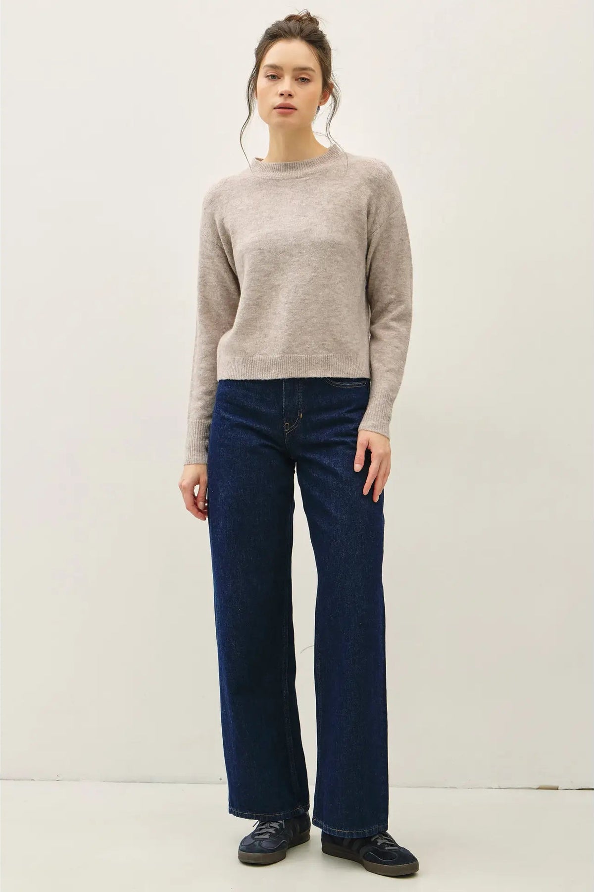 woman in gray sweater and jeans