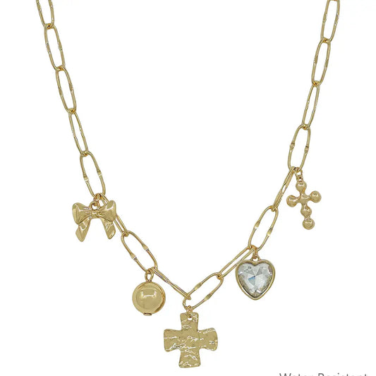 Gold necklace with various charms on a white background