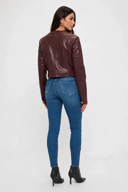 back view of woman in cropped leather jacket and jeans