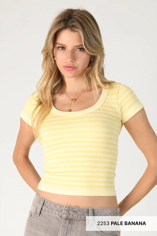 Woman wearing a yellow striped crop top on a white background