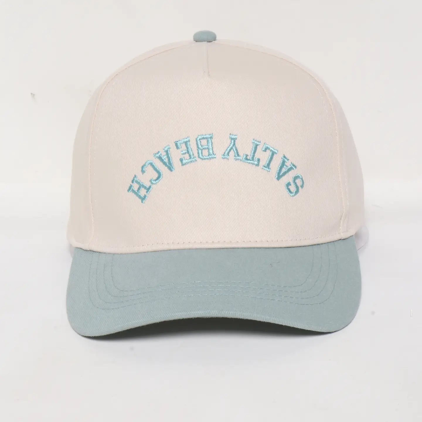baseball hat with salty beach backwards on the front