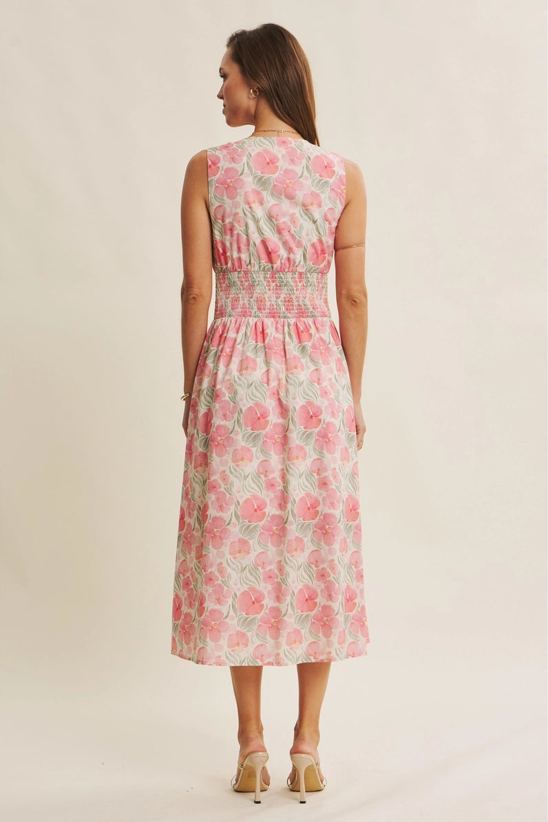 Woman wearing a floral dress on a plain background