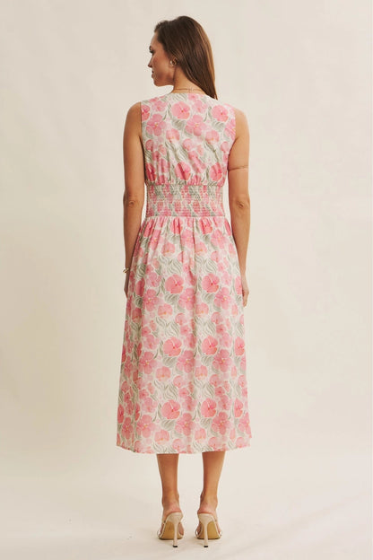 Woman wearing a floral dress on a plain background