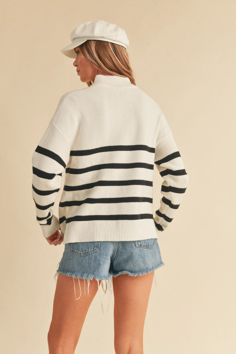 back view of woman in striped sweater and shorts