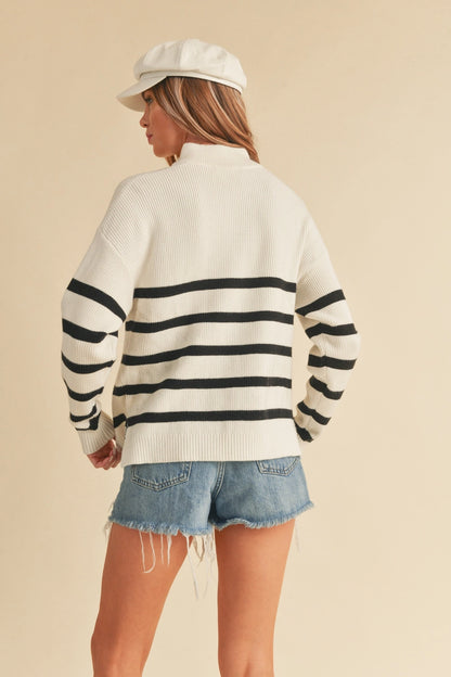 back view of woman in striped sweater and shorts