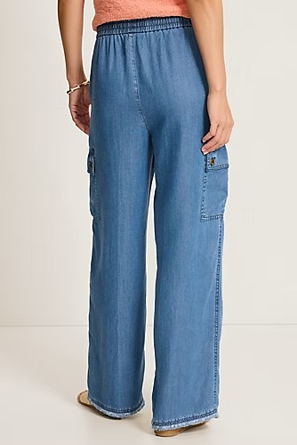 woman wearing denim pants with coral top 