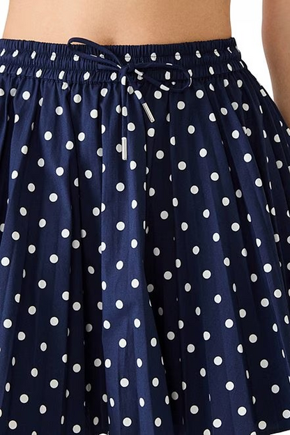 Navy blue skirt with white polka dots on a white background