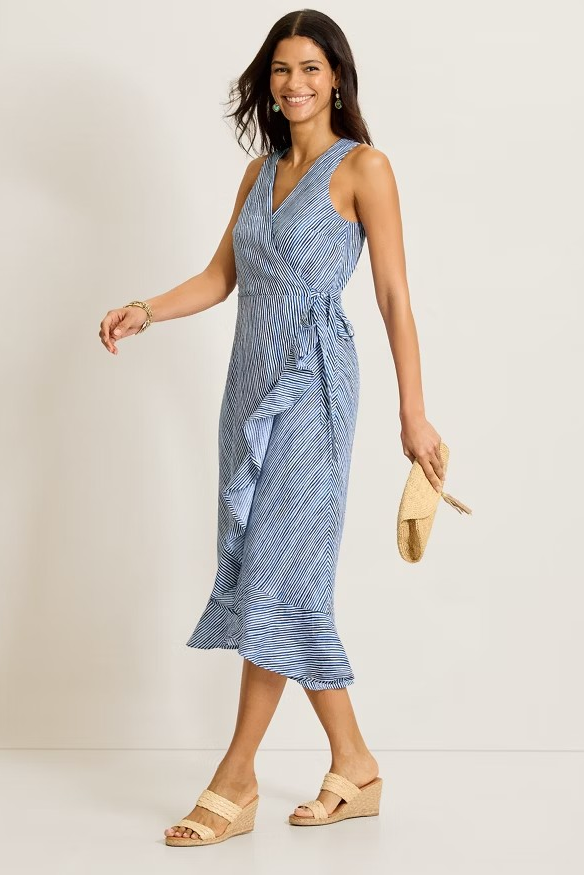 Woman wearing a blue striped dress with a white background