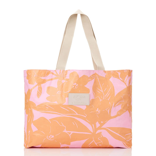 Floral-patterned tote bag with a visible brand label on a white background