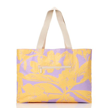 Tote bag with yellow and purple floral pattern on a white background