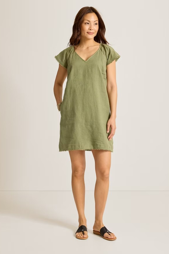 Woman wearing a green dress against a white background