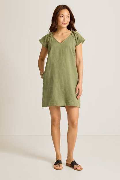Woman wearing a green dress against a white background