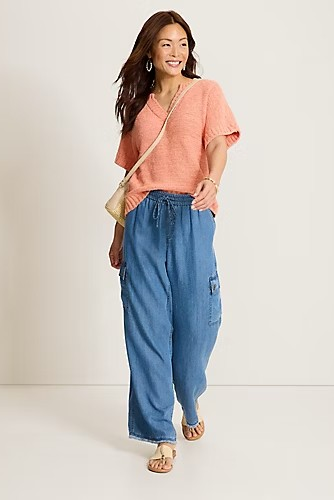 woman wearing denim pants with coral top 