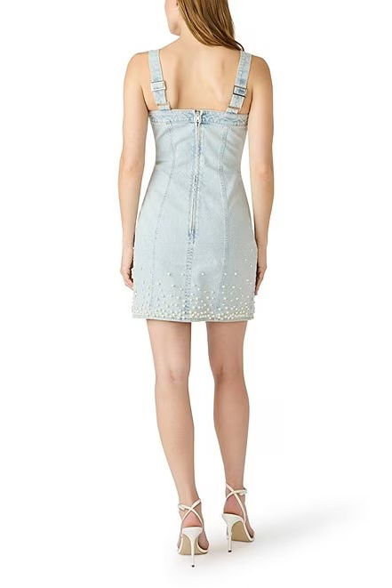Light blue denim dress worn by a model on a white background