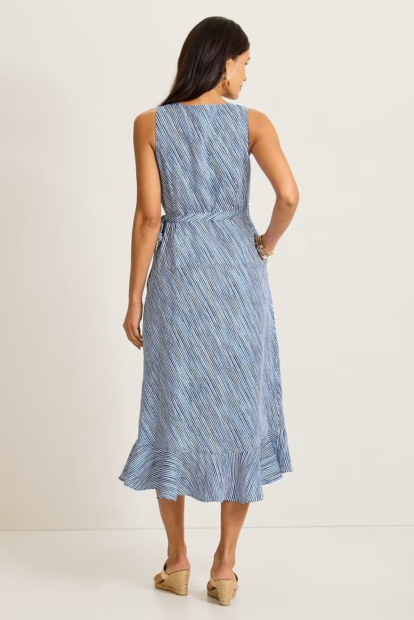 Woman wearing a blue patterned dress against a white background