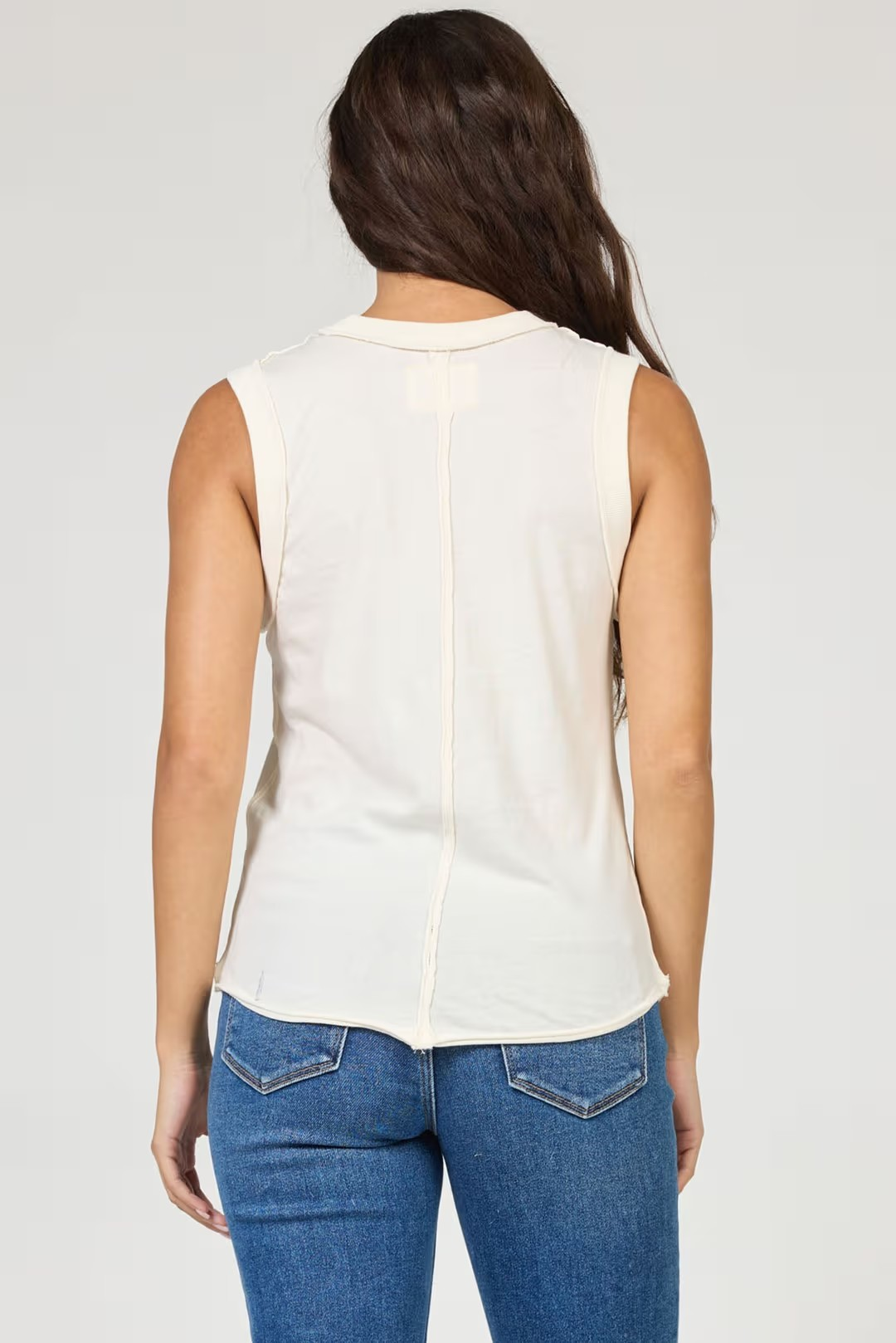 woman wearing cream tank with jeans 