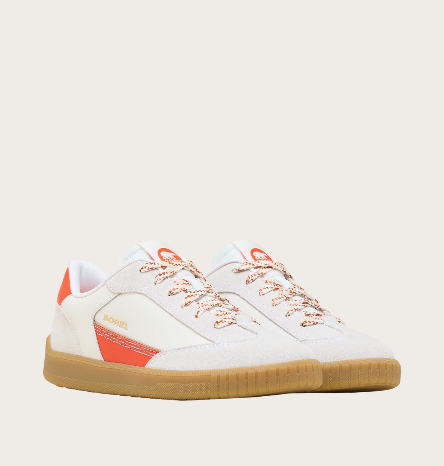 White sneaker with orange accents on a light gray background