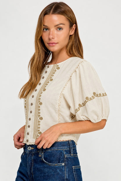 woman in ivory blouse and jeans