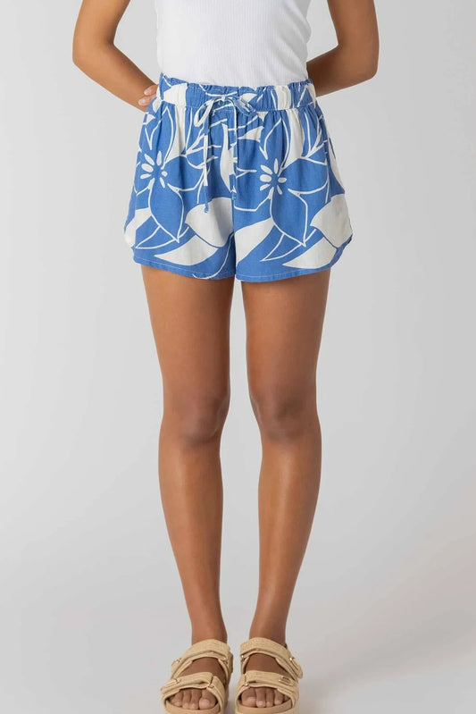Person wearing blue floral shorts on a white background