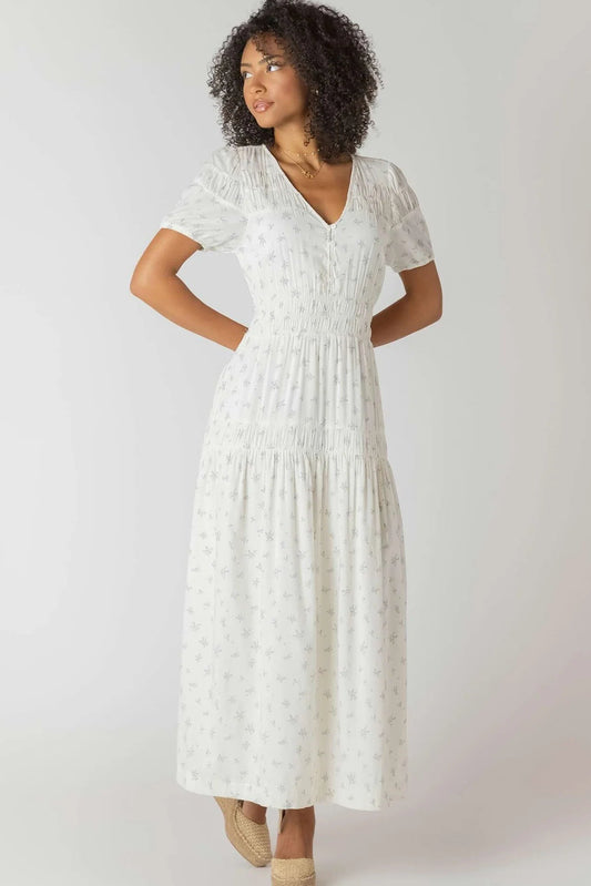 Woman wearing a white lace dress on a plain background