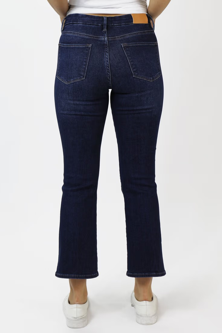person wearing dark wash jeans