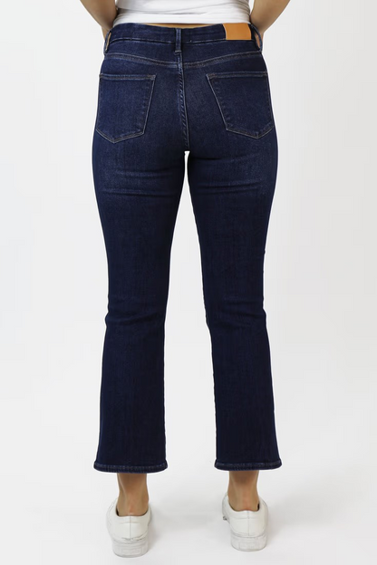 person wearing dark wash jeans