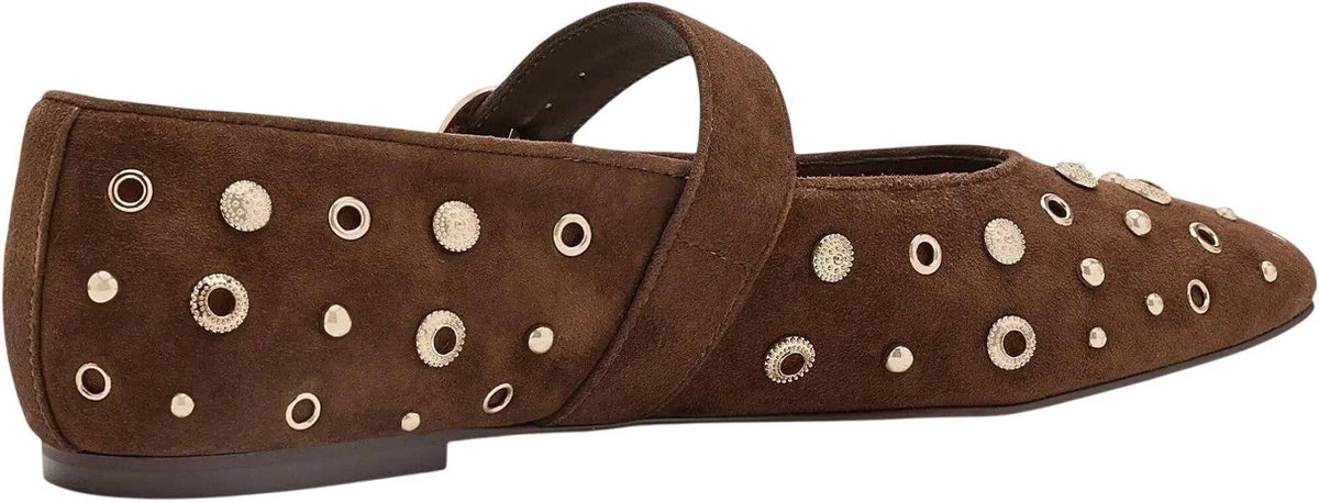 A single brown suede flat shoe with a strap across the top and multiple metallic eyelet embellishments on the side, shown against a plain white background.