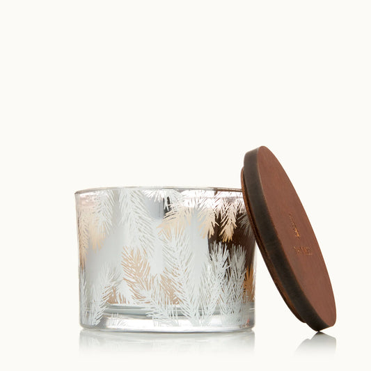 Glass candle with a textured design and a brown lid on a white background