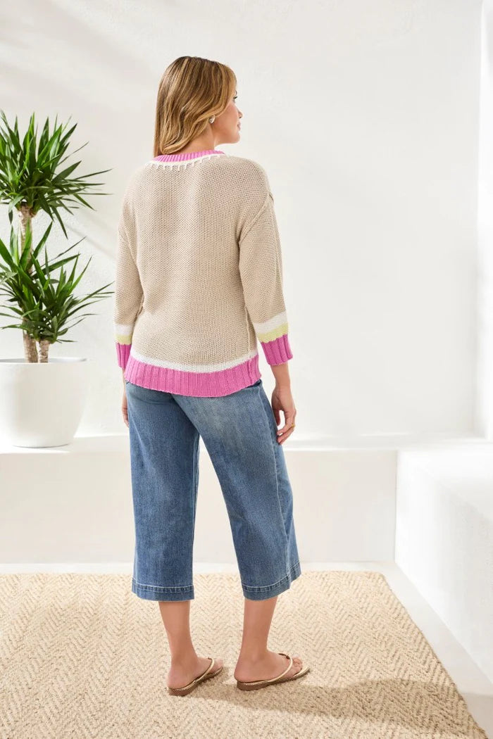 pink and beige sweater on white background